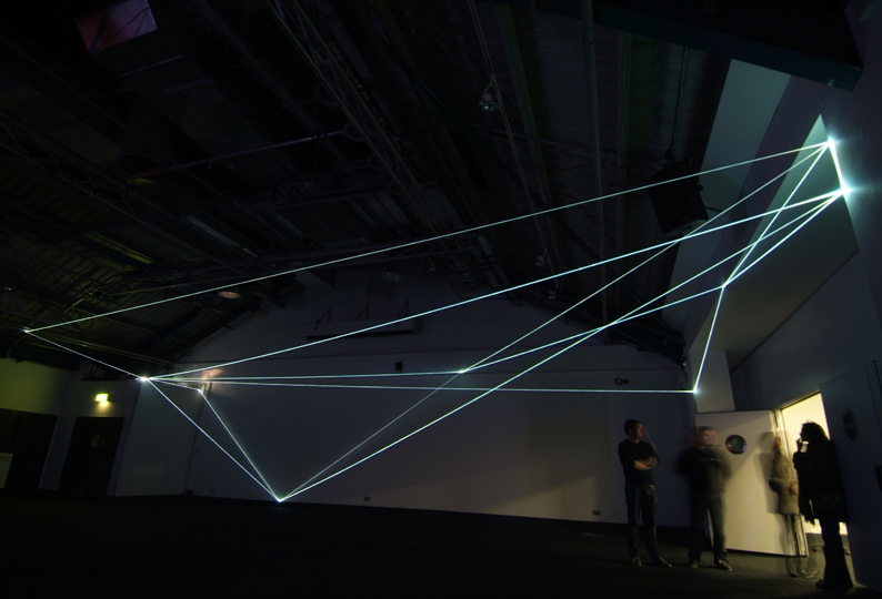 Carlo Bernardini, Drawing of the Vacuum 2011, installazione in fibre ottiche, mt h 5x20x10; Kinetica Art Fair, Prewiew - The Arc Show, Business Design Centre, London.