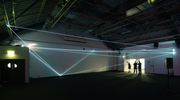 Carlo Bernardini, Drawing of the Vacuum 2011, installazione in fibre ottiche, mt h 5x20x10. Kinetica Art Fair, Prewiew - The Arc Show, Business Design Centre, London.