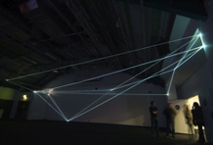 Carlo Bernardini, Drawing of the Vacuum 2011, installazione in fibre ottiche, mt h 5x20x10; Kinetica Art Fair, Prewiew - The Arc Show, Business Design Centre, London.